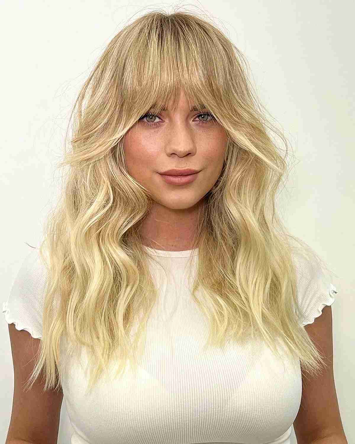 32 Ways to Pair Wavy Hair with Bangs for a Super-Flattering Look