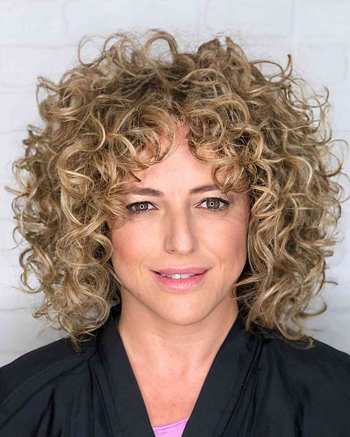 26 Best Ways to Get Curtain Bangs for Curly Hair Right Now